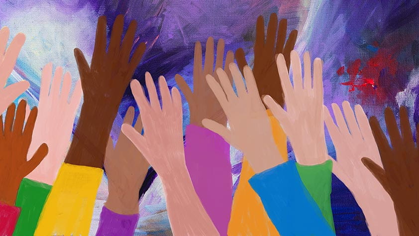 Hands raised by a diverse set of people
