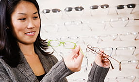 Woman comparing different styles of eyeglasses
