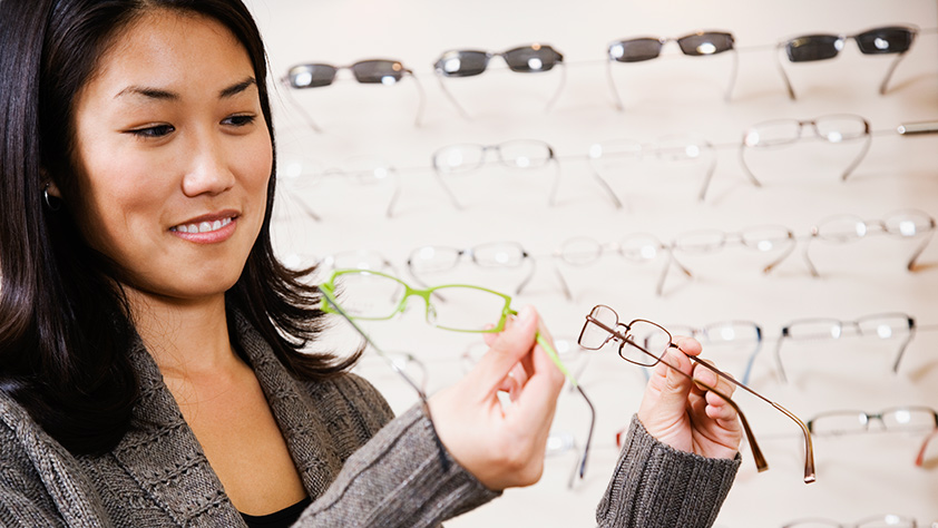 Woman comparing different styles of eyeglasses