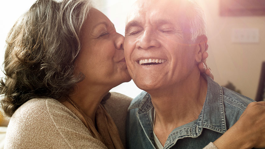 Older couple sharing a happy moment with a joyful kiss