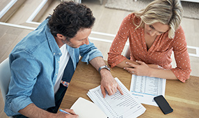 Man and Women Reviewing Paperwork