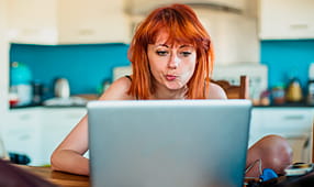 Concerned woman looking at her laptop