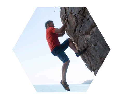 Man free climbing up a rock wall.