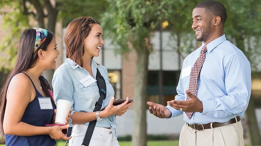Potential College Students Touring Campus With Tour Guide
