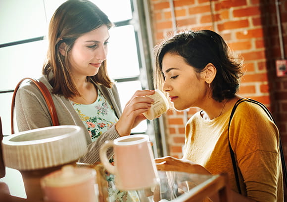 Friends Smelling Candles in a Store