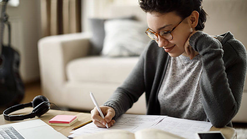 Young woman filling out paperwork