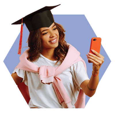 Woman in a Graduation Cap Looking at a Cellphone