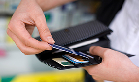 Male Hands Close Up of Credit Card Being Placed into Wallet