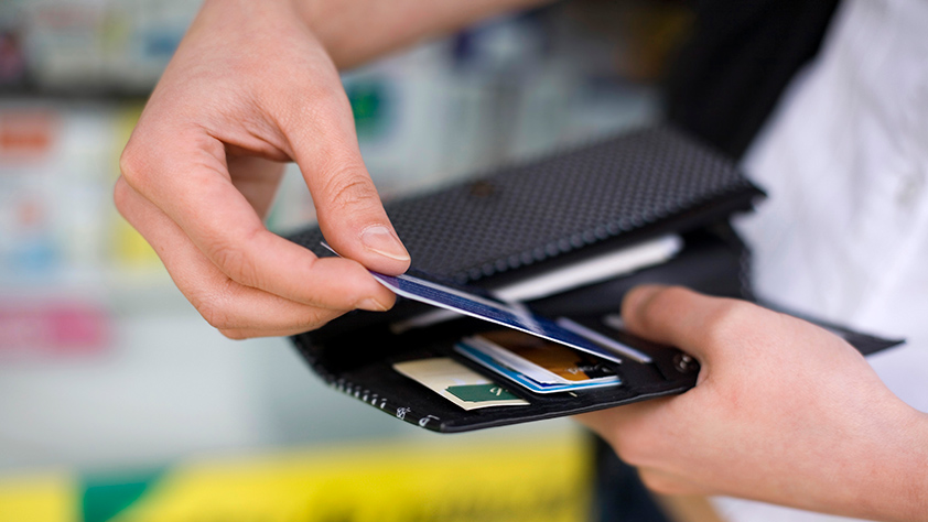 Male Hands Close Up of Credit Card Being Placed into Wallet