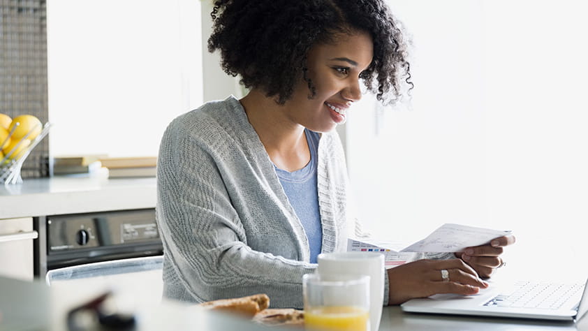 Female Happily Paying Bills Online