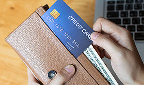 Close Up of Credit Card Being Placed into Wallet