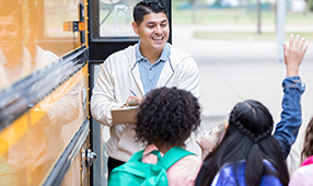 Bus Driver Taking Role of Students Outside of Bus Entrance