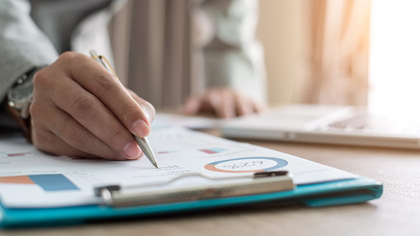 Close Up of Hand Reviewing Financial Information