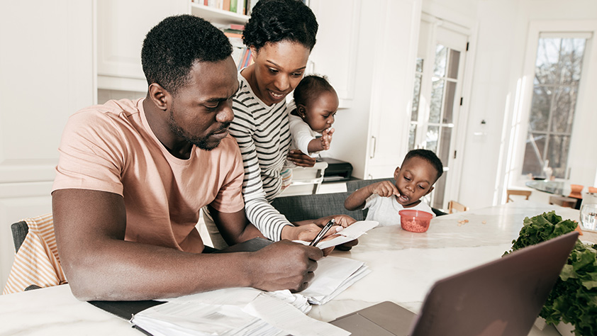 African American Family Enjoying Going Over Bills