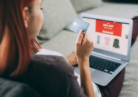 Woman shopping on her laptop using her credit card