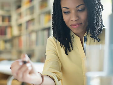 Close Up of Woman Holding Pen