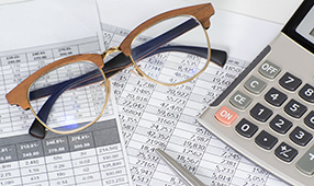 Eye Glasses on Top of Financial Statements
