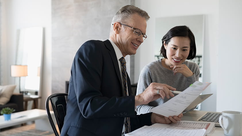 Male Financial Planner Assisting Woman with Finances