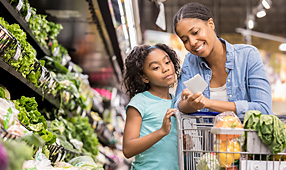 Mother and Daughter Grocery Shop Together Using a List