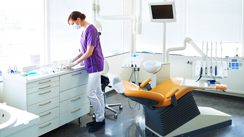 Dental Hygienist Prepping Dental Office Chair