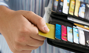 Hand Pulling Out Credit Card