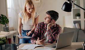 Worried Young Couple Paying Bills Online