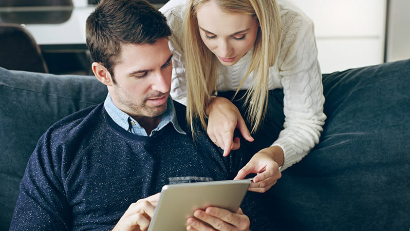 Couple using their digital tablet