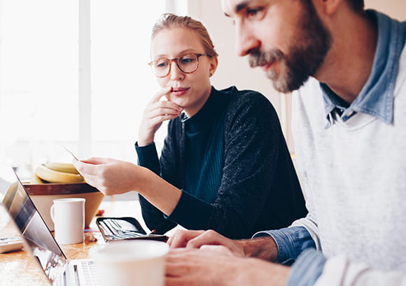 Couple in Cafe Looking Over Paperwork