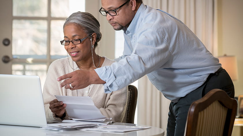 Couple doing work on a laptop