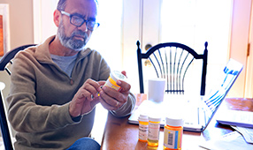 Senior Looking Intently at Medication Bottle