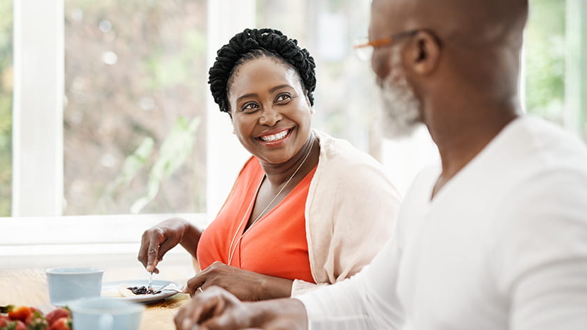 Senior couple eating breakfast together