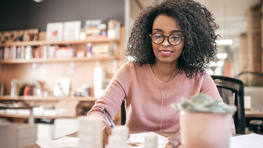 African-American woman working on financial paperwork