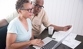 African American Seniors Reviewing Finances Online