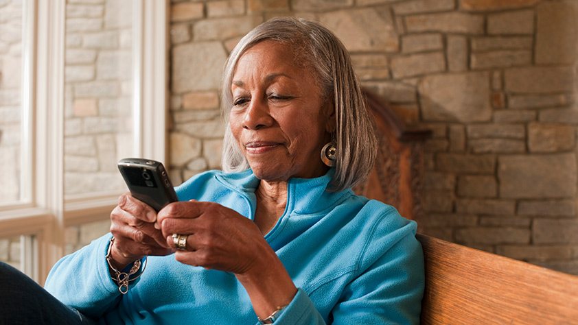 Senior woman looking at her cellphone