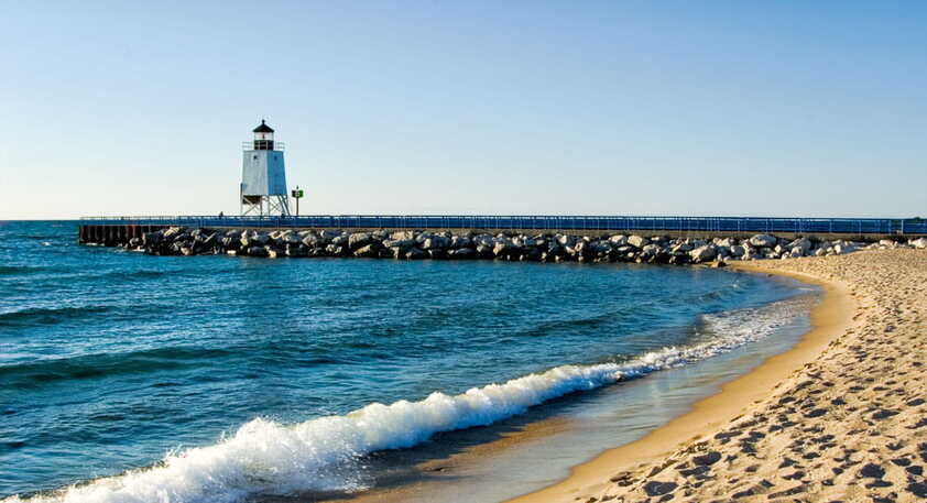 Lighthouse and sandy beach on the Great Lakes in Michigan