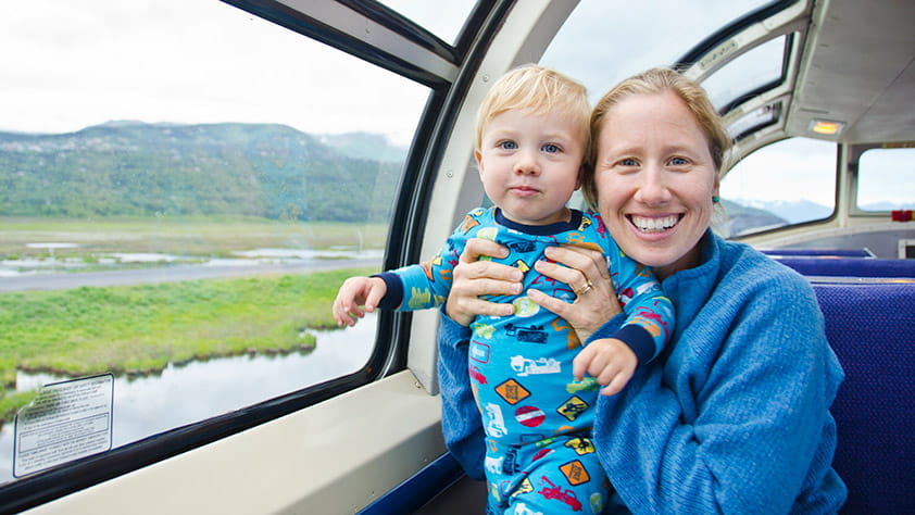 Mother and toddler son riding on a train