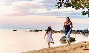 Mother Chasing Daughter on Beach