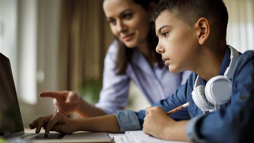 Virtual Field Trips - Mother Helping Teenager with Homework on a Laptop