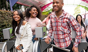 Group of young people arriving at an amusement park and looking very happy