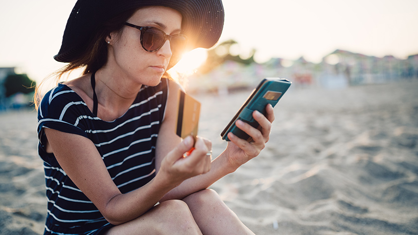 Woman on Smartphone on Beach