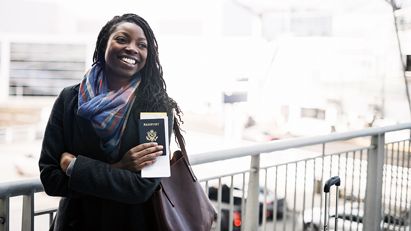 Woman Holding a Passport and Tickets