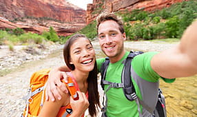 Happy Couple Taking a Selfie While Hiking
