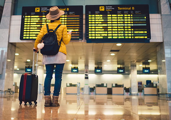 Woman Reviewing Flights at Airport