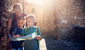 Teacher Helping Children Review Map on Field Trip