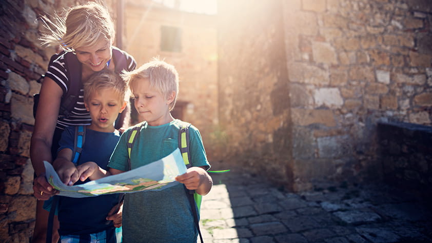 Teacher Helping Children Review Map on Field Trip
