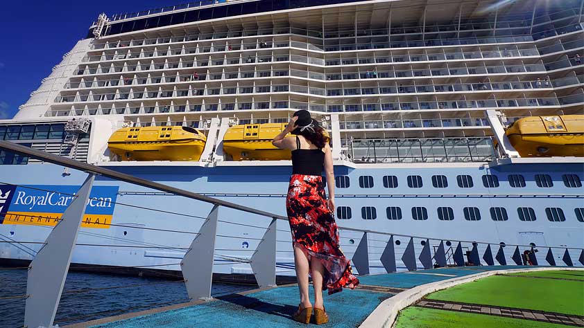 Traveling Solo? Why a Cruise is the Best Way to Go - Woman Looking at a Cruise Ship 