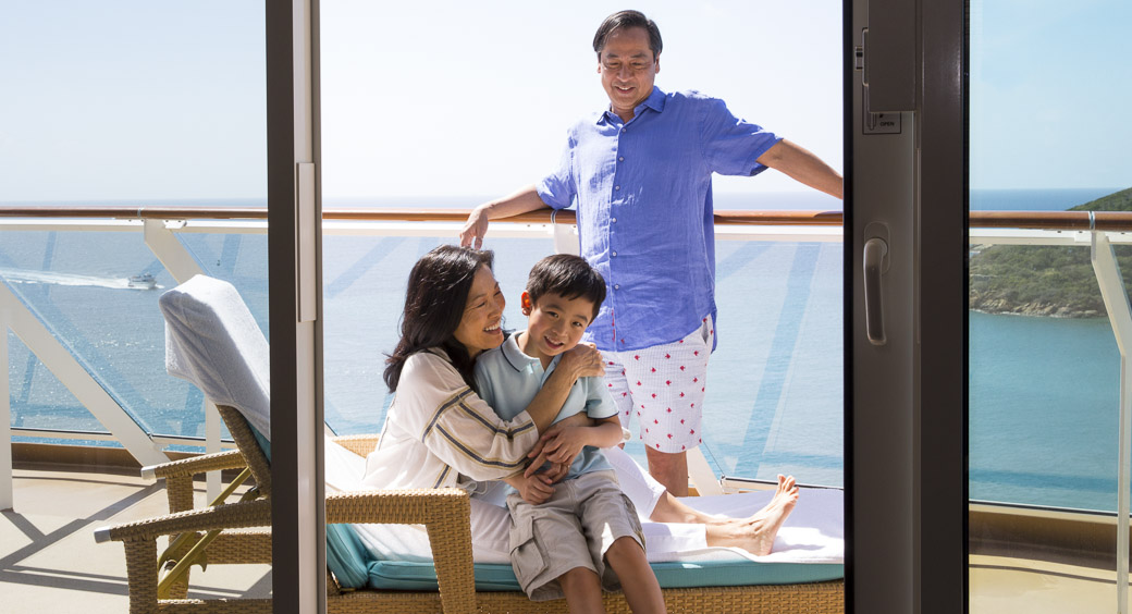 Family sitting on the deck of a cruise ship