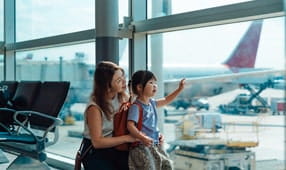 NEA member smiling with her daughter at the airport