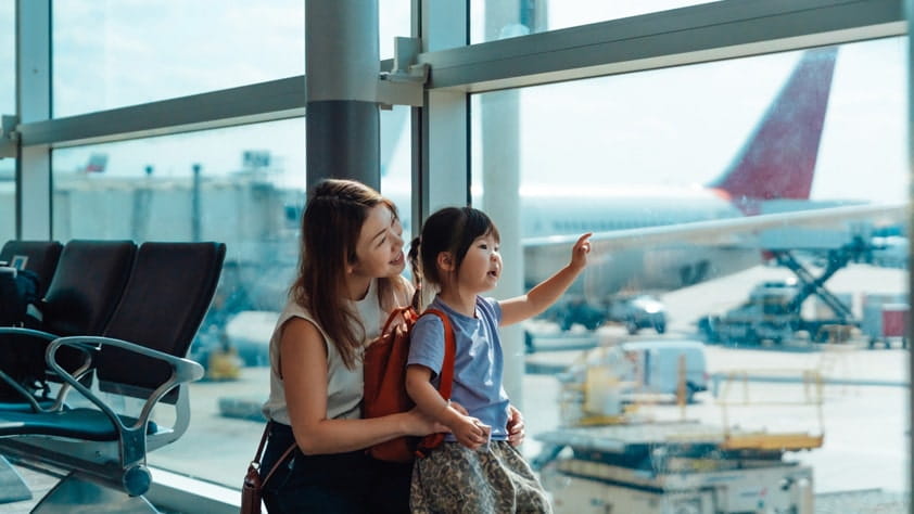 NEA member smiling with her daughter at the airport