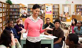 Woman Addressing Peers in Library